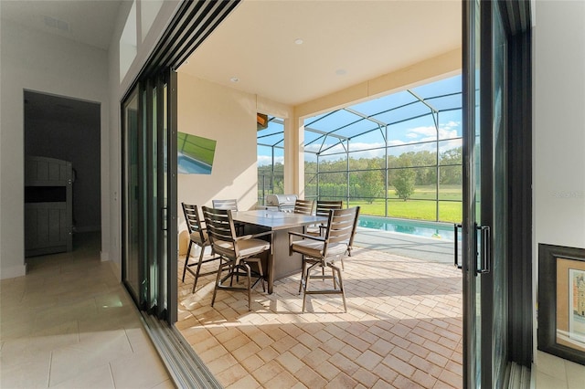 view of patio with glass enclosure