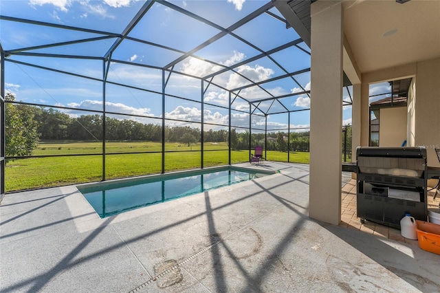 view of pool featuring a lawn, a patio, and glass enclosure