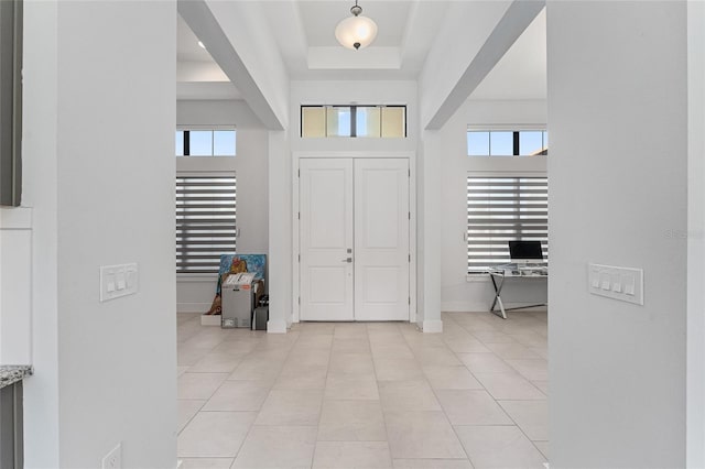 tiled foyer with a high ceiling