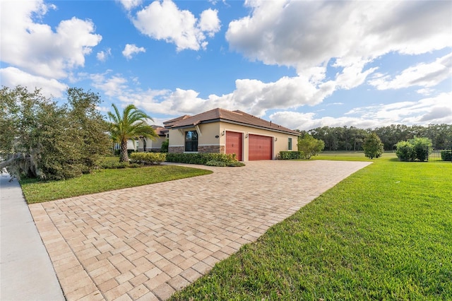 mediterranean / spanish home featuring a garage and a front yard