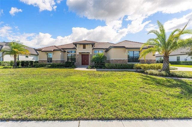 mediterranean / spanish-style home featuring a front lawn