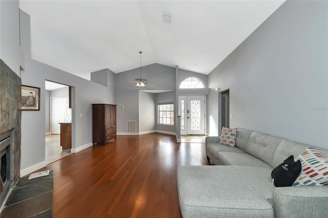 living room with wood-type flooring and vaulted ceiling