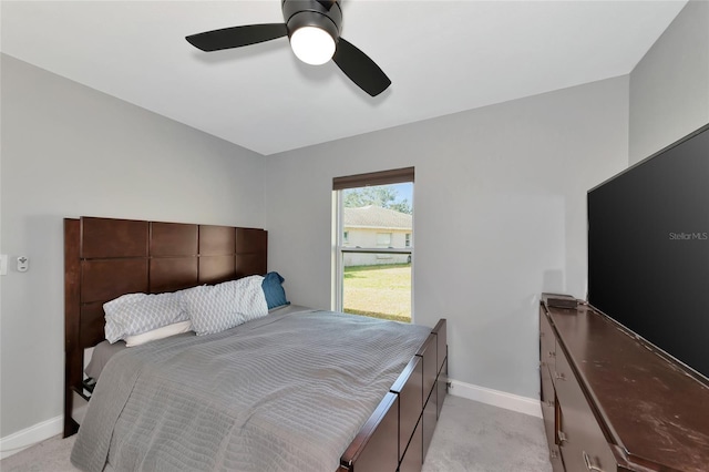 bedroom featuring light colored carpet and ceiling fan