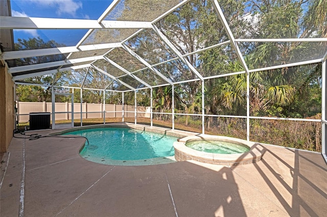 view of pool with an in ground hot tub, a lanai, central air condition unit, and a patio area