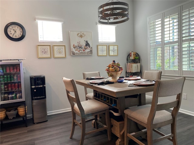 dining area featuring dark hardwood / wood-style floors, beverage cooler, and a wealth of natural light