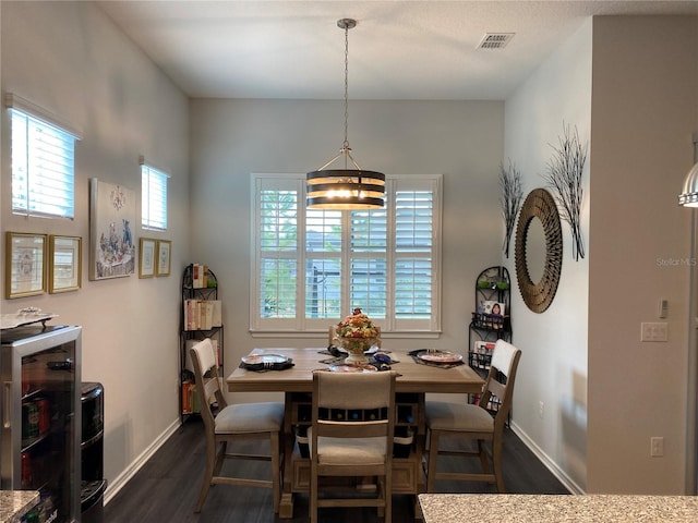 dining room featuring a notable chandelier and dark hardwood / wood-style flooring