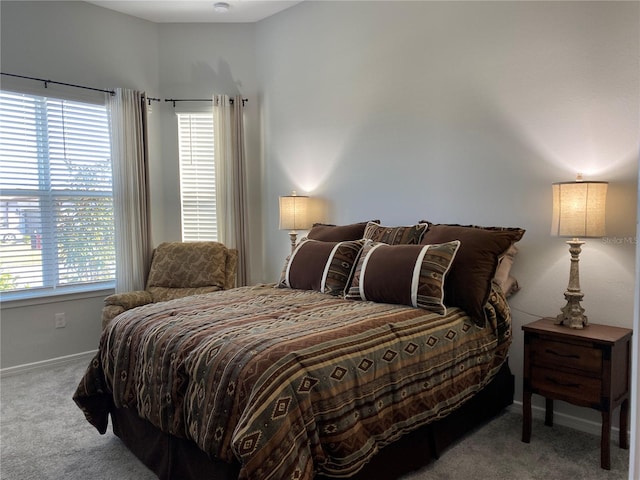 bedroom featuring multiple windows and light colored carpet