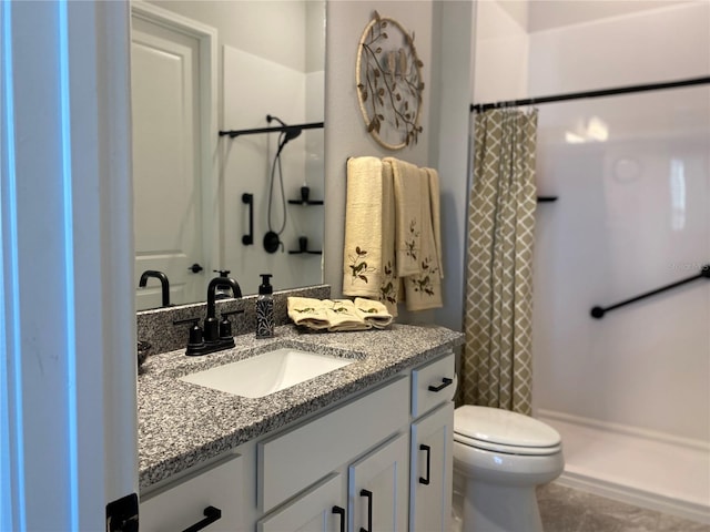 bathroom featuring tile patterned flooring, vanity, curtained shower, and toilet