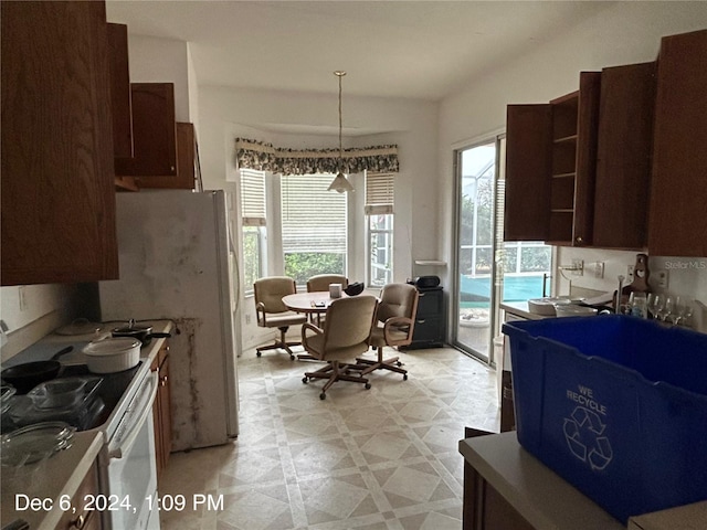 kitchen featuring white range with gas stovetop and hanging light fixtures