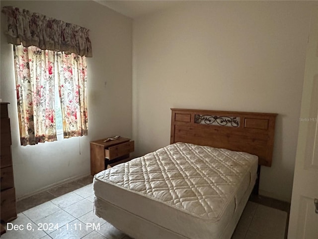 bedroom with light tile patterned floors