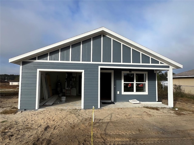 view of front of property with a garage and an outdoor structure