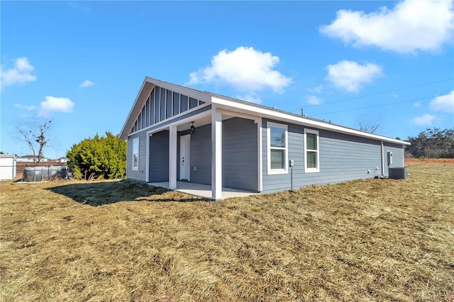 view of home's exterior featuring a patio, a yard, and central air condition unit