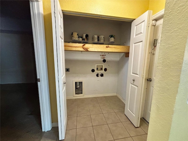 laundry room with electric dryer hookup, gas dryer hookup, light tile patterned floors, and washer hookup