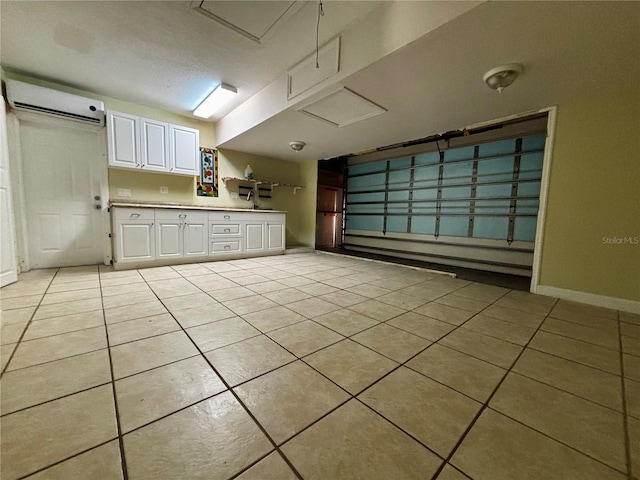 3 Redwood Run Radl, Ocala, FL 34472 - kitchen with a wall mounted air conditioner, light tile patterned floors, white cabinetry, and light countertops