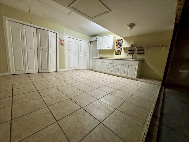 3 Redwood Run Radl, Ocala, FL 34472 - kitchen with light tile patterned flooring, white cabinetry, light countertops, and a wall mounted air conditioner