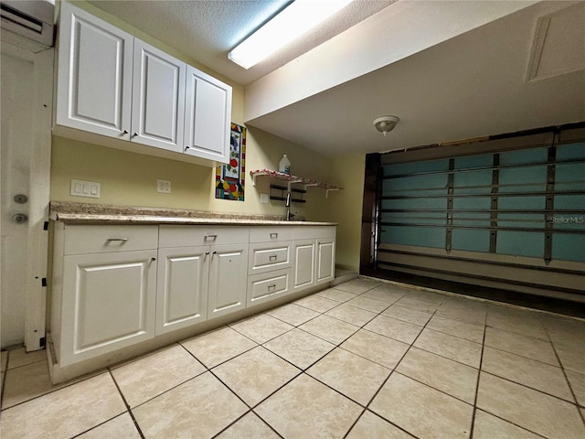 3 Redwood Run Radl, Ocala, FL 34472 - kitchen featuring white cabinets, light tile patterned floors, and a wall mounted AC