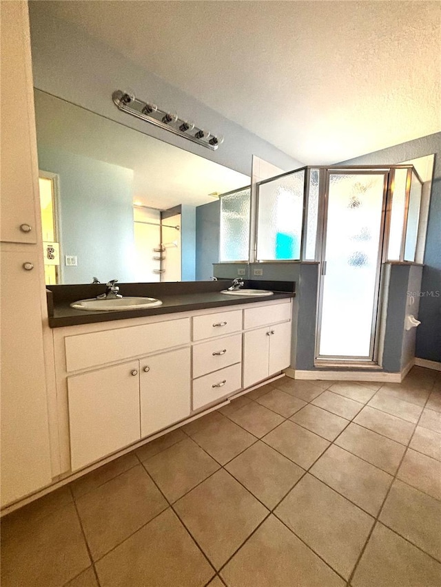 3 Redwood Run Radl, Ocala, FL 34472 - bathroom featuring double vanity, tile patterned flooring, a textured ceiling, and a stall shower