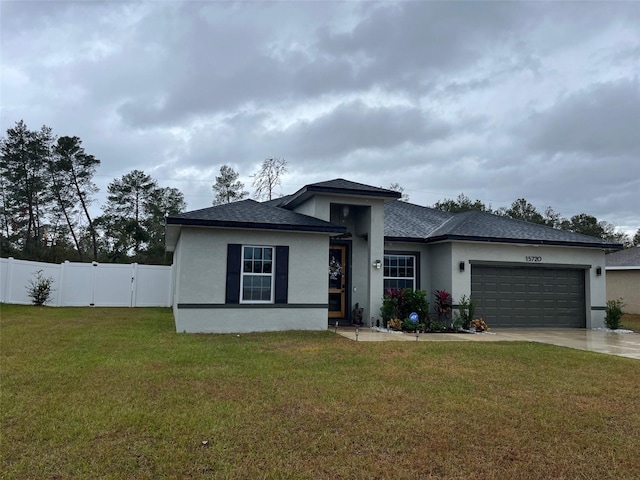 view of front of house featuring a garage and a front yard