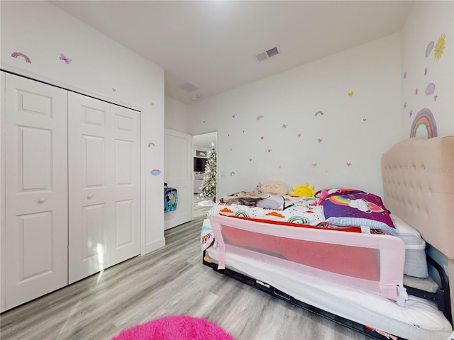 bedroom featuring a closet and light hardwood / wood-style flooring