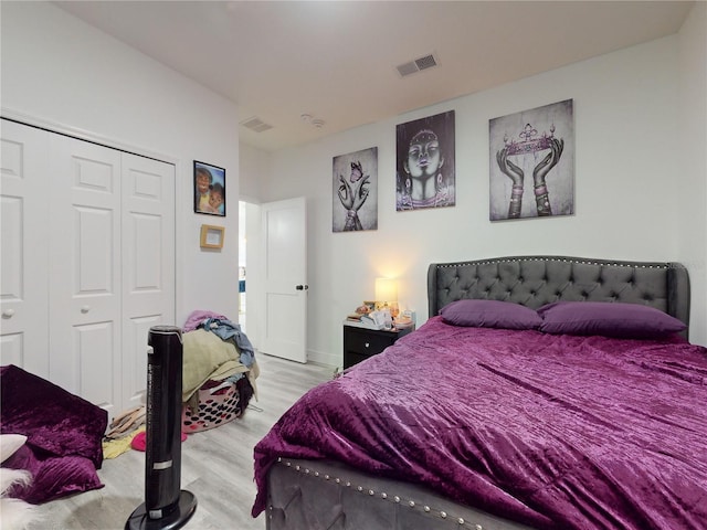 bedroom featuring a closet and light wood-type flooring