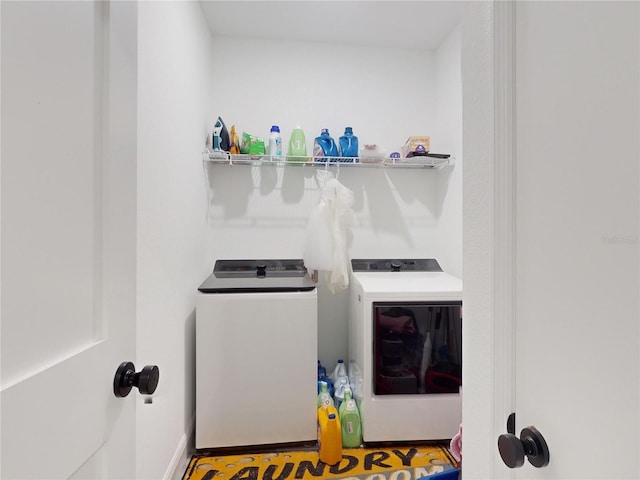 clothes washing area featuring washing machine and clothes dryer