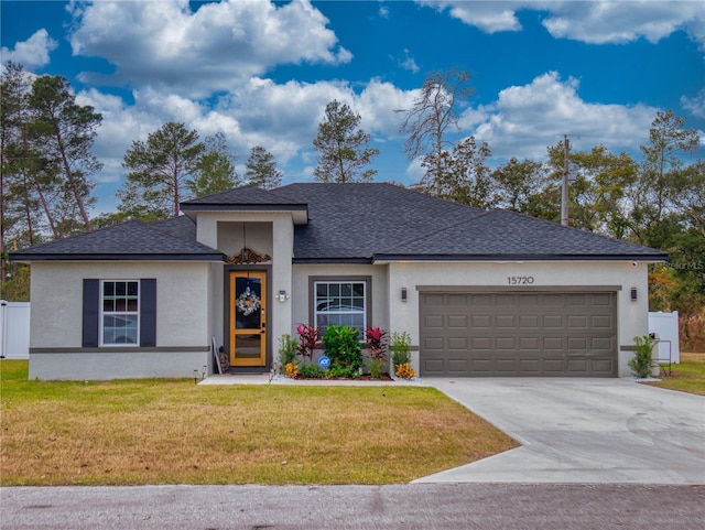 view of front of house featuring a front yard and a garage