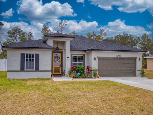 prairie-style home with a garage and a front lawn