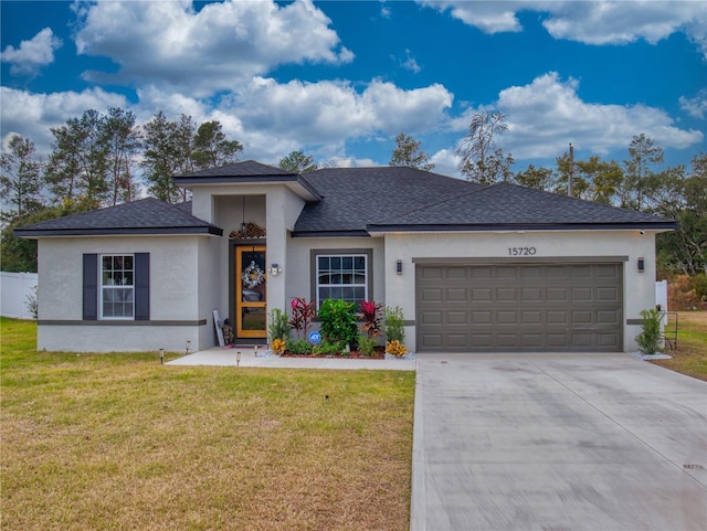 view of front of home featuring a garage and a front yard