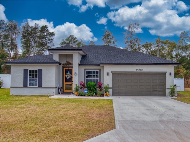 view of front of house with a front lawn and a garage