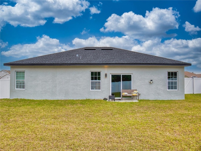 back of property with a lawn and an outdoor hangout area