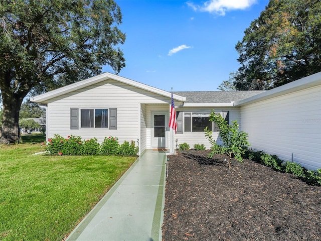 ranch-style house featuring a front lawn