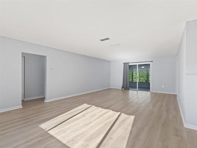 unfurnished room with light hardwood / wood-style floors