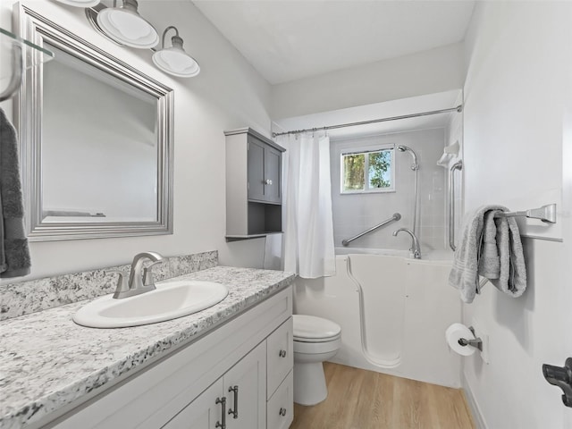 bathroom featuring wood-type flooring, vanity, and toilet