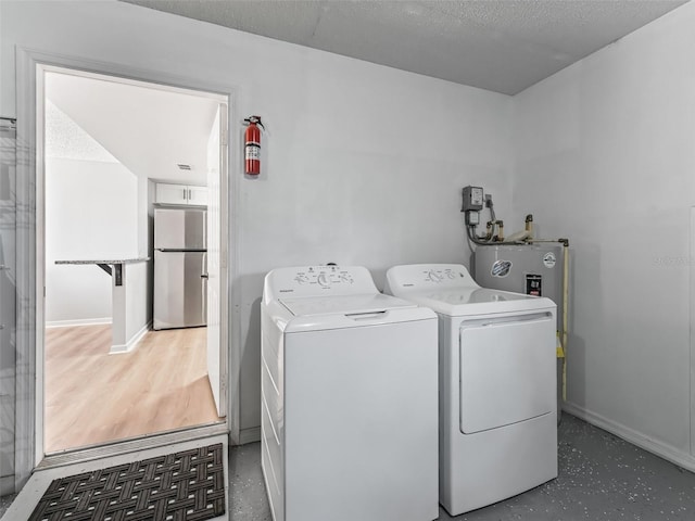 washroom featuring dark hardwood / wood-style floors, washing machine and dryer, and a textured ceiling