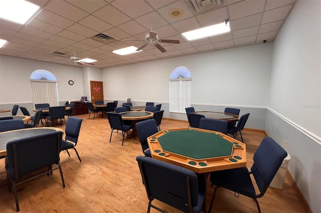 game room with a paneled ceiling, hardwood / wood-style flooring, and ceiling fan