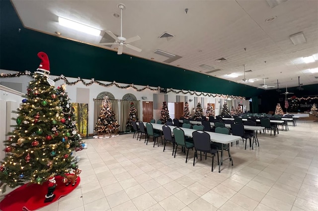 unfurnished dining area with ceiling fan and light tile patterned floors