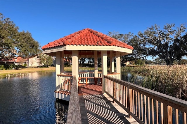 view of dock with a gazebo and a water view