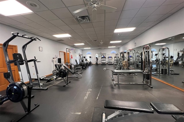 gym featuring a paneled ceiling and ceiling fan