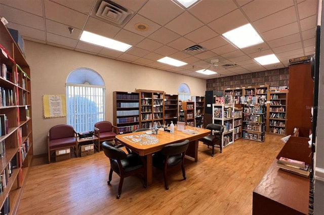 office featuring a paneled ceiling and hardwood / wood-style floors