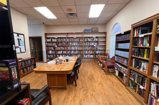 office featuring a drop ceiling and light hardwood / wood-style flooring