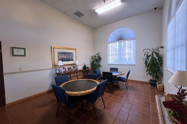 tiled dining area with high vaulted ceiling