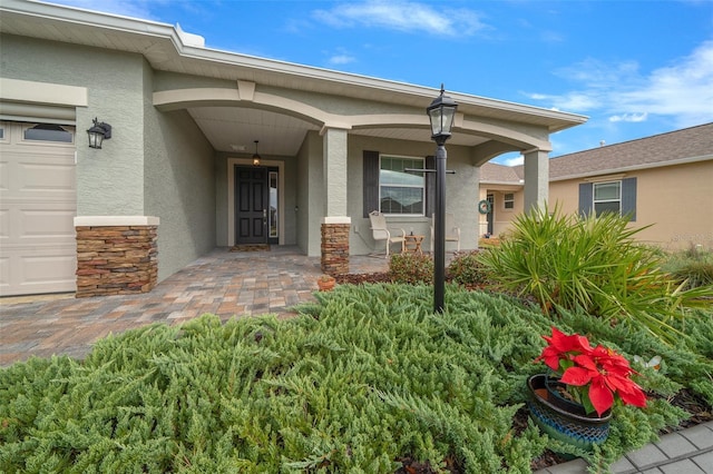 property entrance with covered porch and a garage