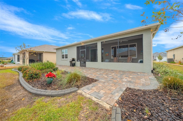 back of property featuring a sunroom and a patio area