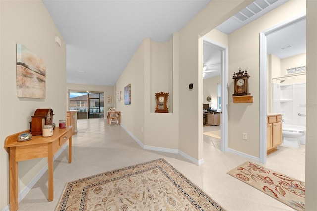 corridor with light tile patterned flooring