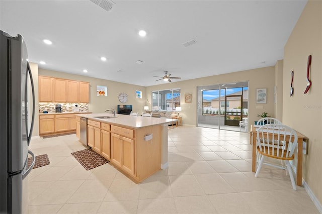 kitchen featuring a center island with sink, sink, ceiling fan, light brown cabinetry, and stainless steel appliances