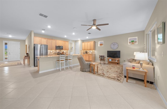 tiled living room with ceiling fan