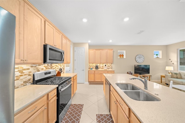 kitchen featuring backsplash, light brown cabinets, sink, and appliances with stainless steel finishes