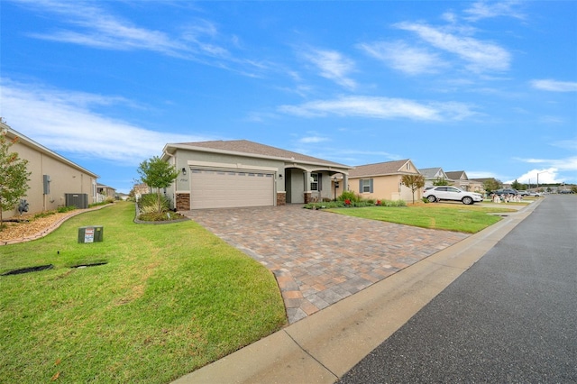 ranch-style home with a front yard, a garage, and central AC unit