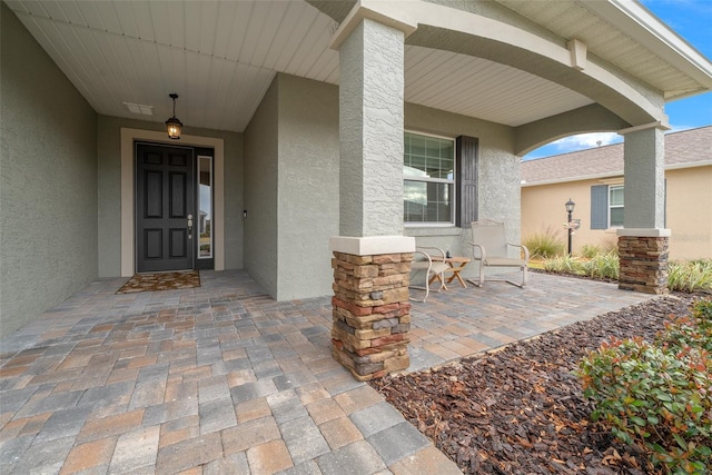 doorway to property with a porch