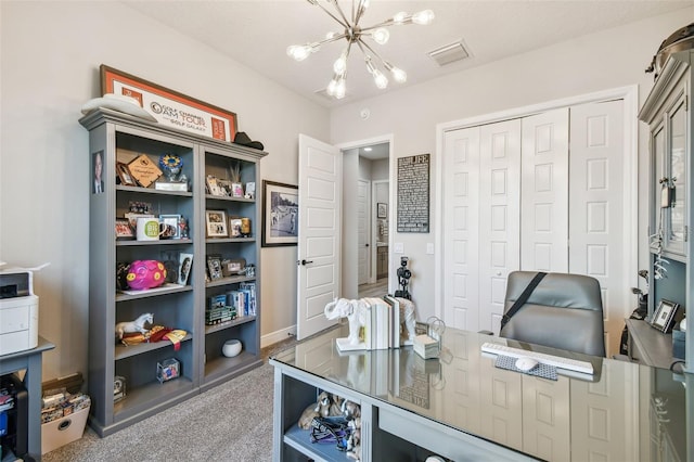 carpeted office with a notable chandelier